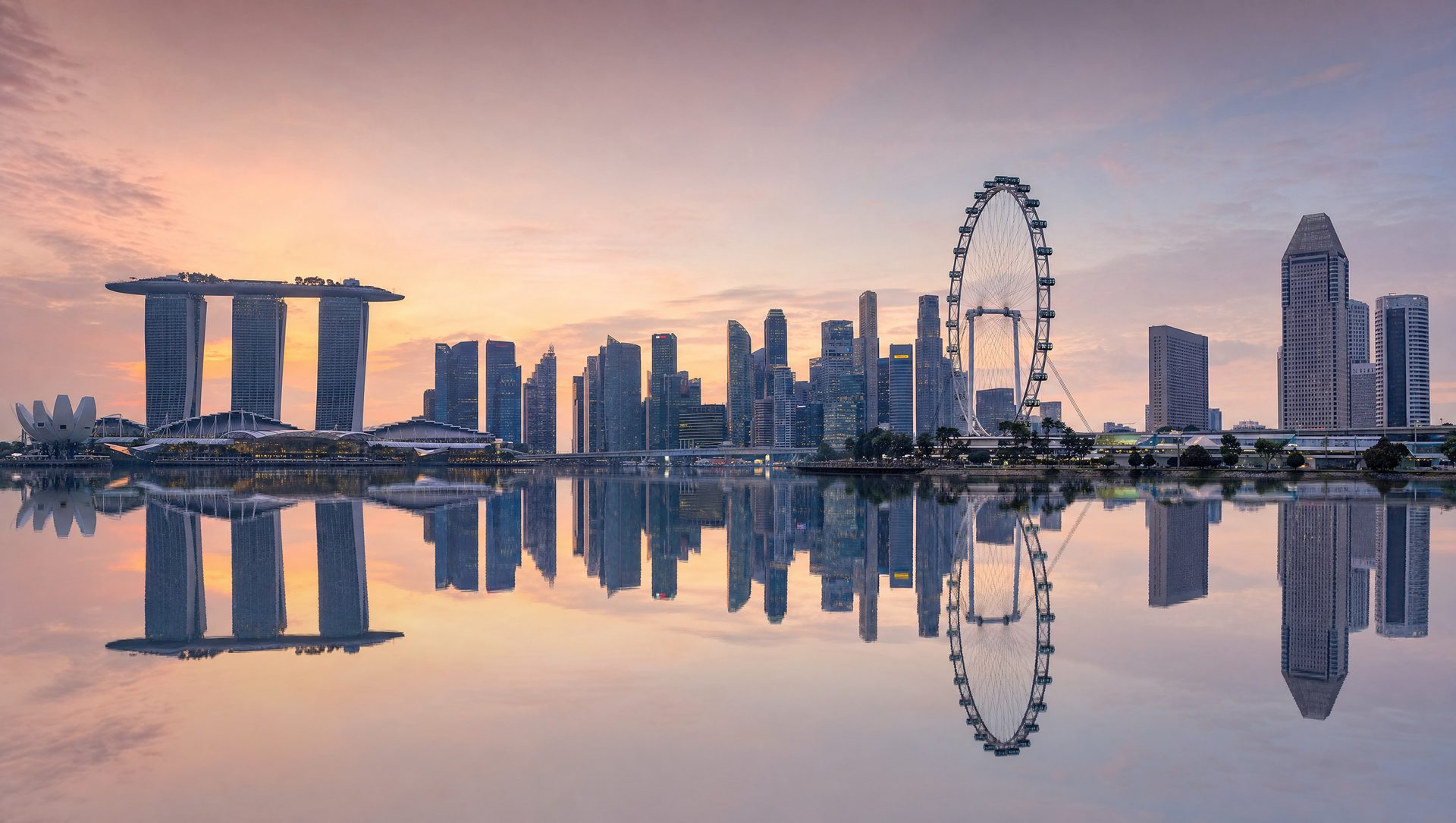 Singapore skyline at first light across still water